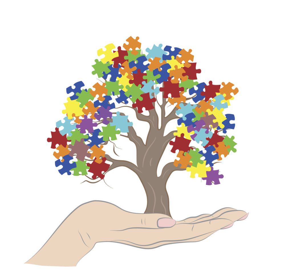 Un dessin d'une main tient un arbre dont les feuilles colorées sont des morceaux de puzzle